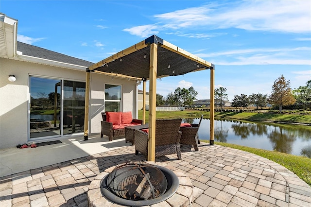 view of patio with a water view and a fire pit