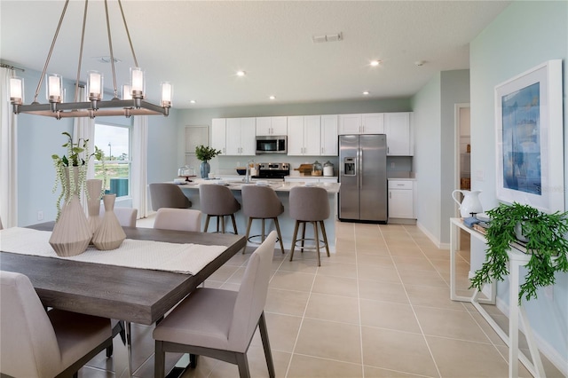 dining room with light tile patterned floors and sink