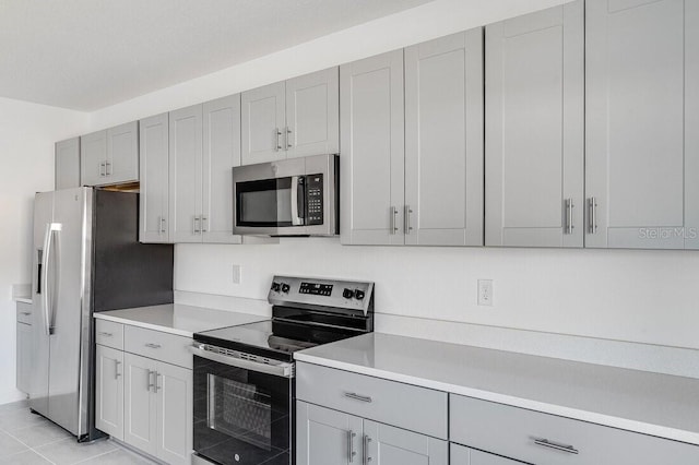 kitchen with stainless steel appliances and light tile patterned floors