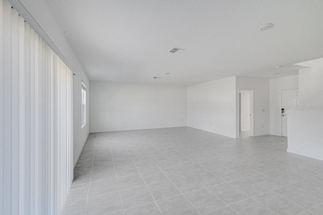 spare room with a textured ceiling