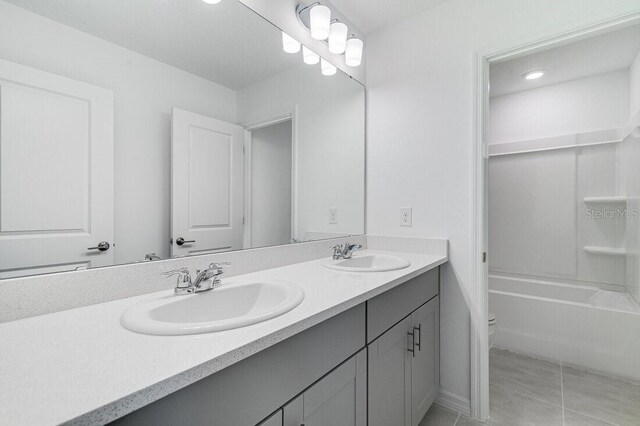 full bathroom with tile patterned flooring, vanity, shower / bath combination, and toilet