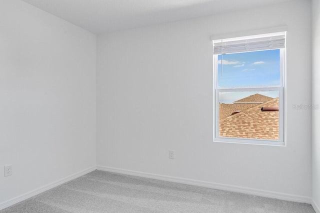 unfurnished room featuring carpet flooring