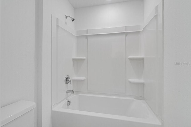 bathroom with toilet and  shower combination