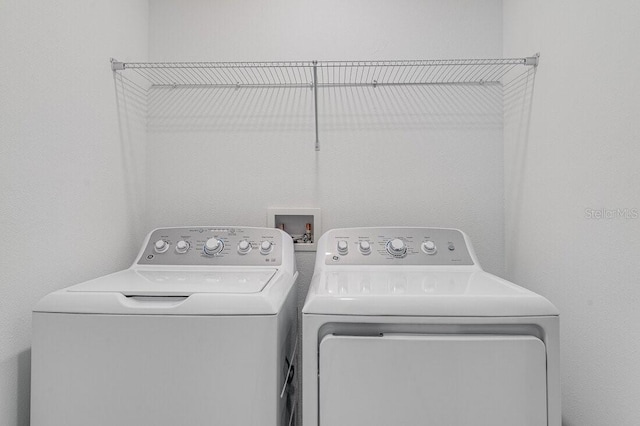 washroom with washing machine and clothes dryer