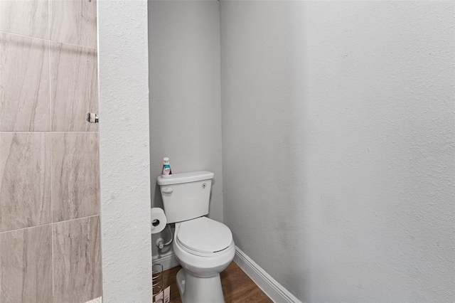 bathroom with hardwood / wood-style flooring and toilet