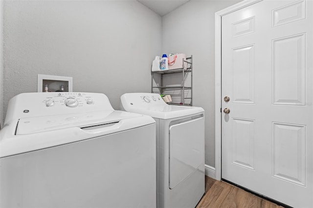 washroom with dark hardwood / wood-style flooring and washer and dryer