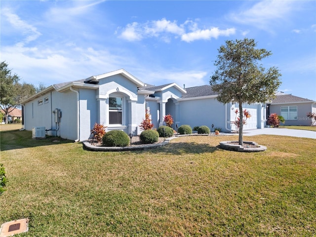 single story home featuring central AC unit, a garage, and a front yard