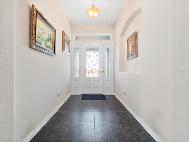 entrance foyer featuring dark tile patterned flooring