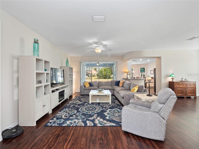 living room featuring dark hardwood / wood-style floors and ceiling fan