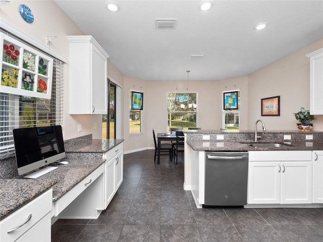 kitchen featuring dark stone countertops, sink, white cabinets, and dishwasher