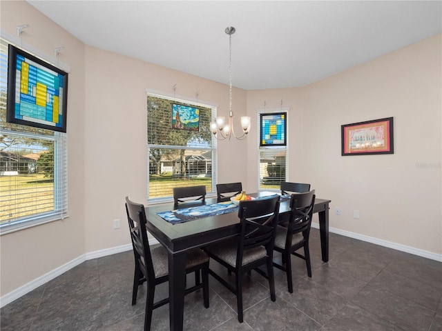 dining area featuring a wealth of natural light and a notable chandelier