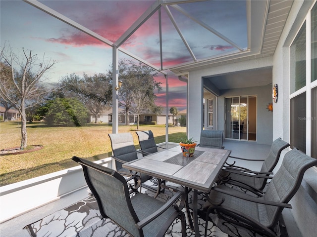 patio terrace at dusk featuring a yard