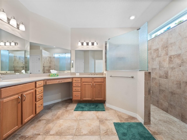 bathroom with vanity and tiled shower