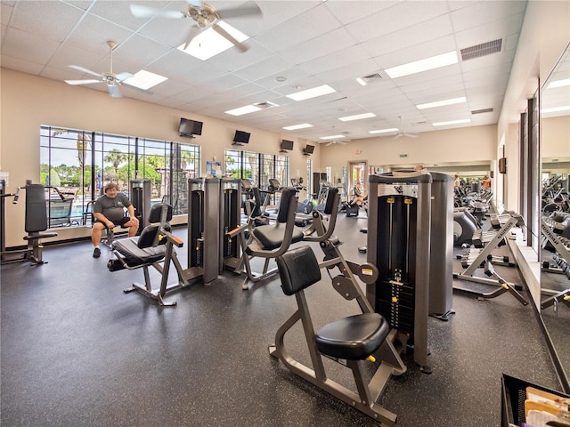 workout area featuring a drop ceiling and ceiling fan