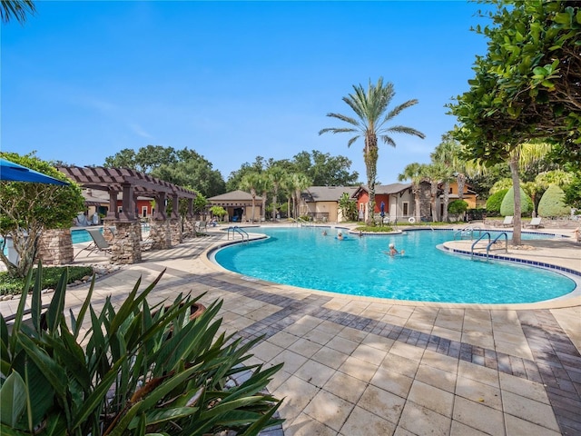 view of pool with a pergola and a patio