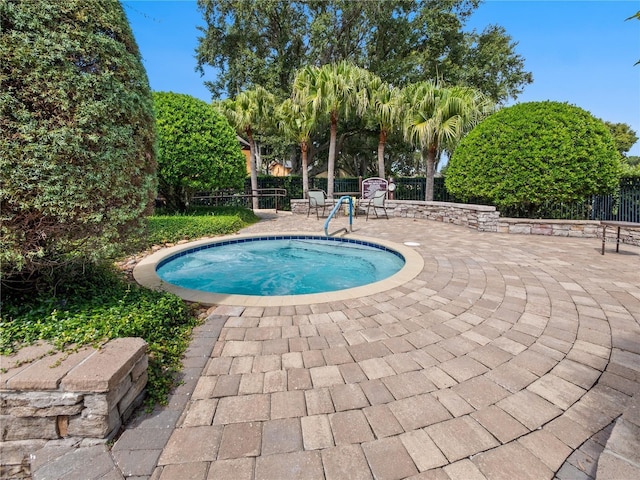 view of swimming pool featuring a patio area