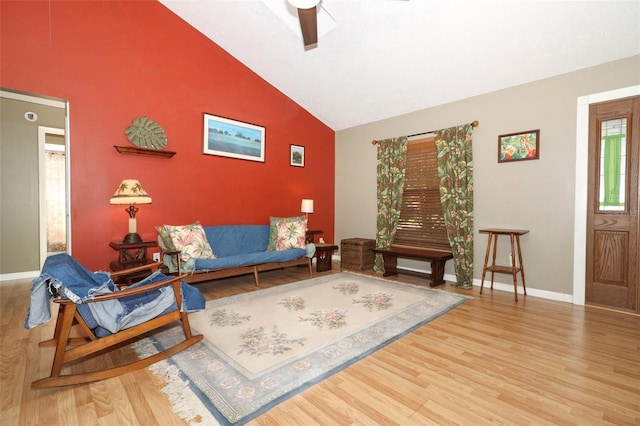 living room featuring ceiling fan, hardwood / wood-style floors, and lofted ceiling