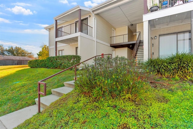 view of side of home with a lawn