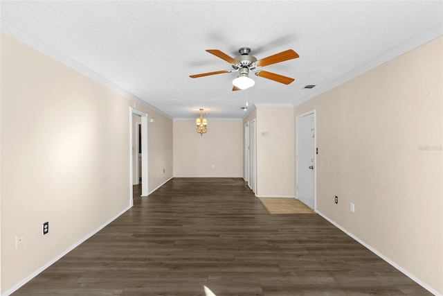 interior space with ornamental molding, a textured ceiling, dark hardwood / wood-style floors, and a notable chandelier