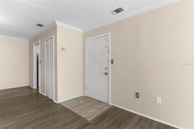 interior space featuring a textured ceiling, crown molding, and dark wood-type flooring