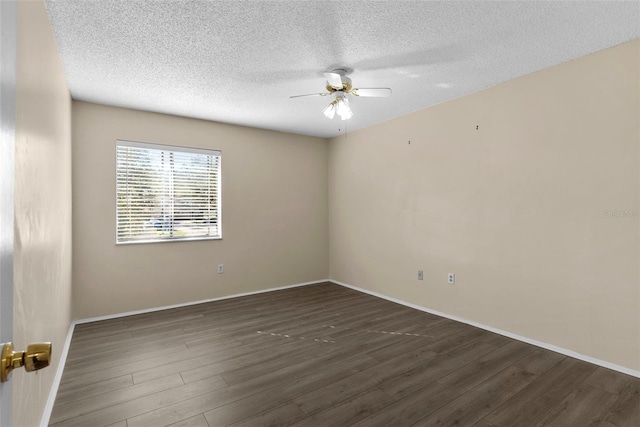 empty room featuring a textured ceiling, dark hardwood / wood-style flooring, and ceiling fan