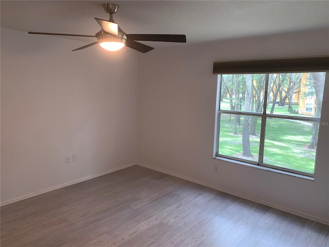 unfurnished room with ceiling fan and wood-type flooring