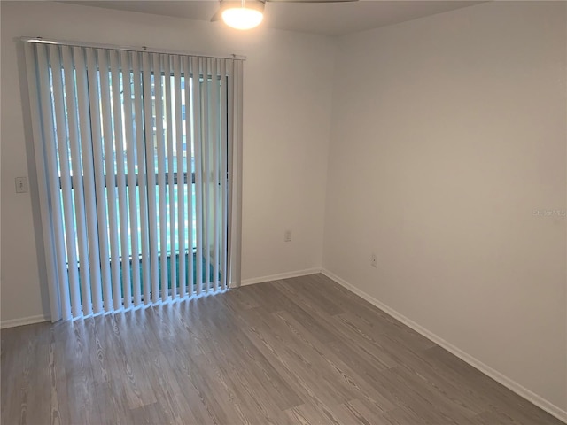 unfurnished room with wood-type flooring