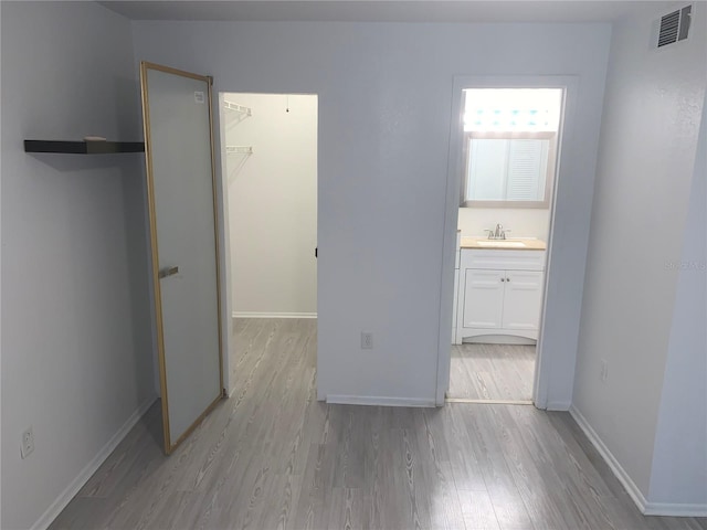 hallway featuring light hardwood / wood-style floors and sink