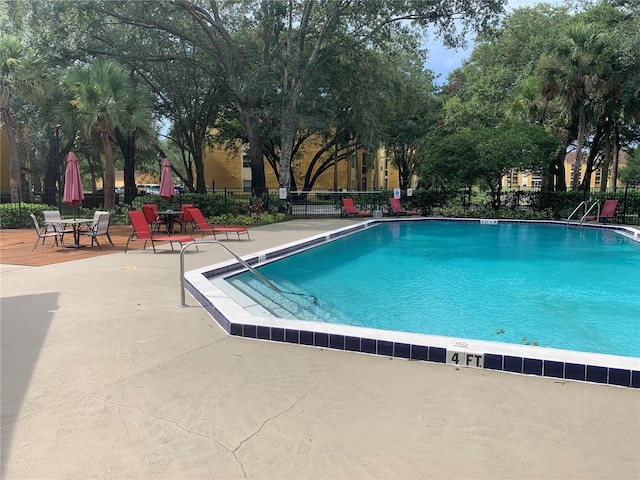 view of swimming pool featuring a patio area