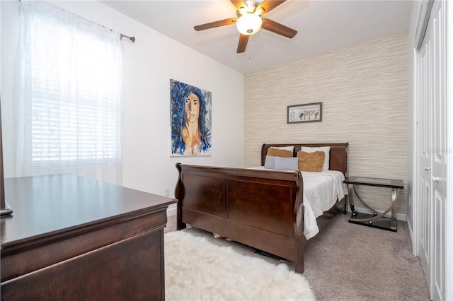 bedroom featuring light carpet, a closet, and ceiling fan