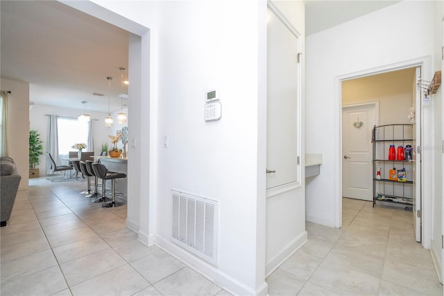 hallway featuring light tile patterned floors