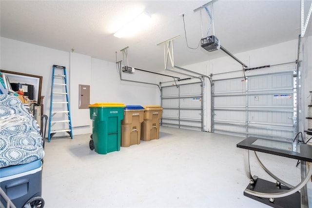 garage with electric panel and a garage door opener