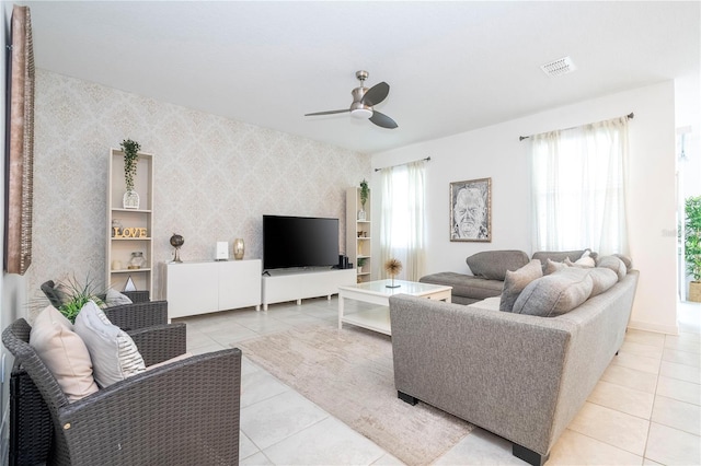 tiled living room with ceiling fan