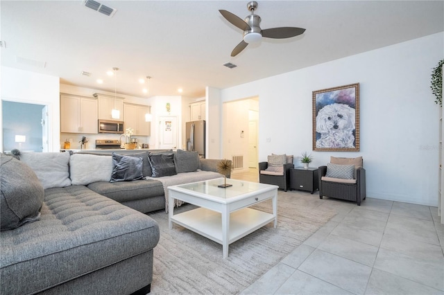 tiled living room with ceiling fan