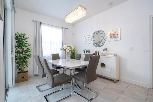 dining room with light tile patterned floors and an inviting chandelier