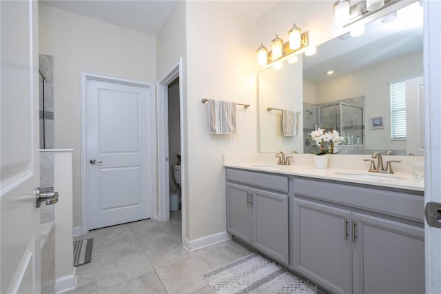 bathroom featuring tile patterned floors, vanity, and a shower with shower door