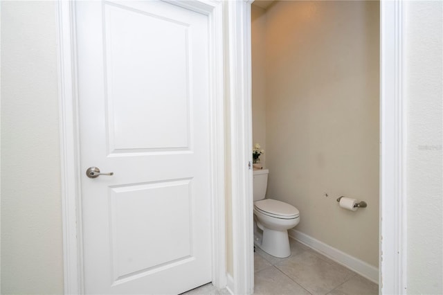 bathroom with tile patterned flooring and toilet