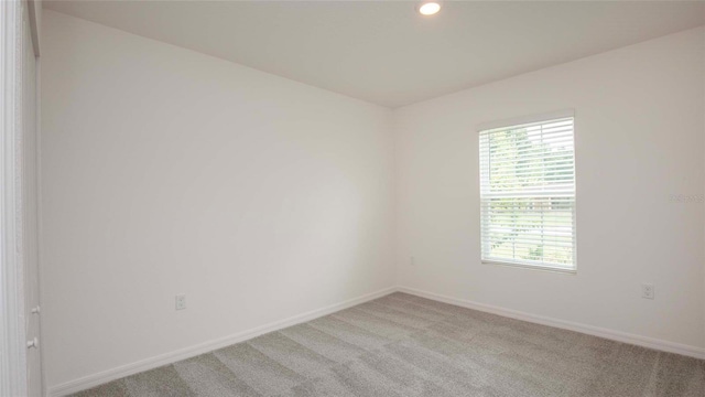 spare room with light carpet