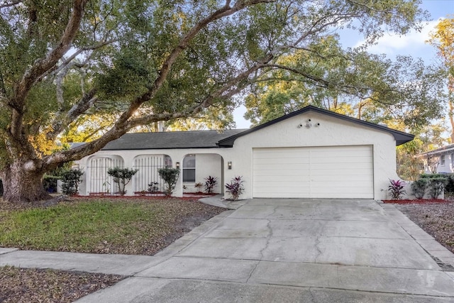 single story home with driveway, an attached garage, and stucco siding