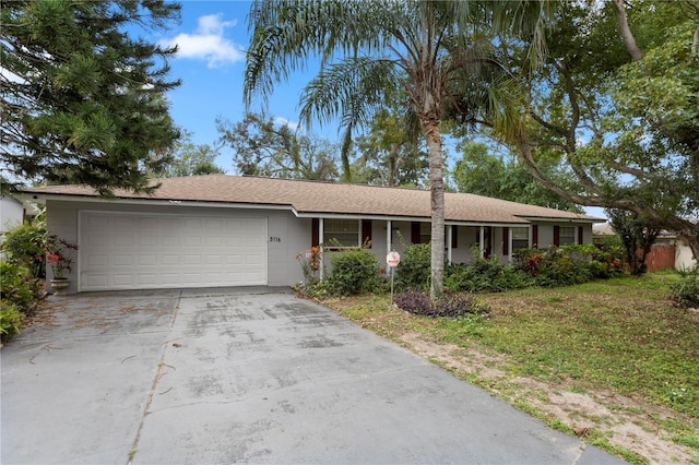 single story home with a front yard and a garage