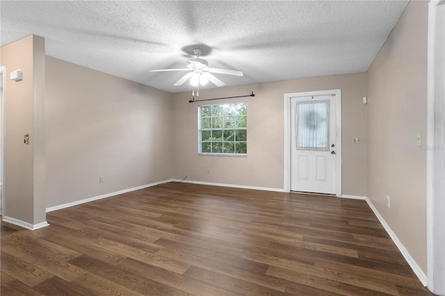 entrance foyer with dark hardwood / wood-style flooring, a textured ceiling, and ceiling fan