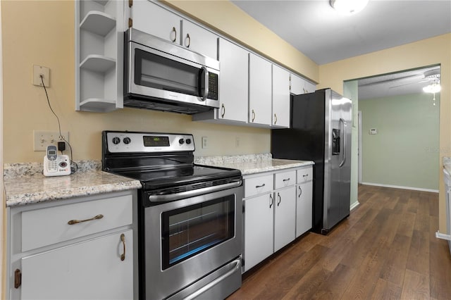 kitchen featuring stainless steel appliances, dark hardwood / wood-style flooring, and white cabinets