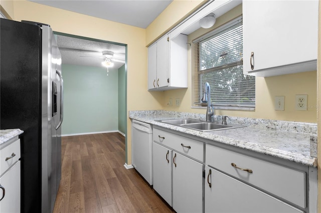 kitchen featuring sink, white cabinetry, white dishwasher, stainless steel fridge, and dark hardwood / wood-style flooring