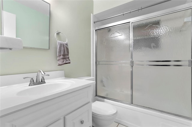 full bathroom featuring enclosed tub / shower combo, vanity, and toilet