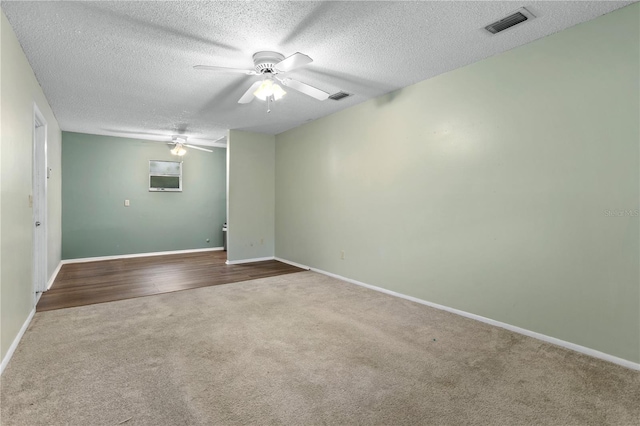 carpeted empty room featuring a textured ceiling