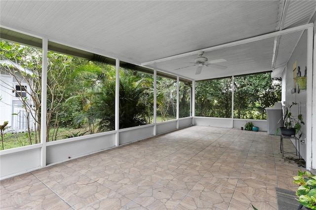 unfurnished sunroom featuring ceiling fan