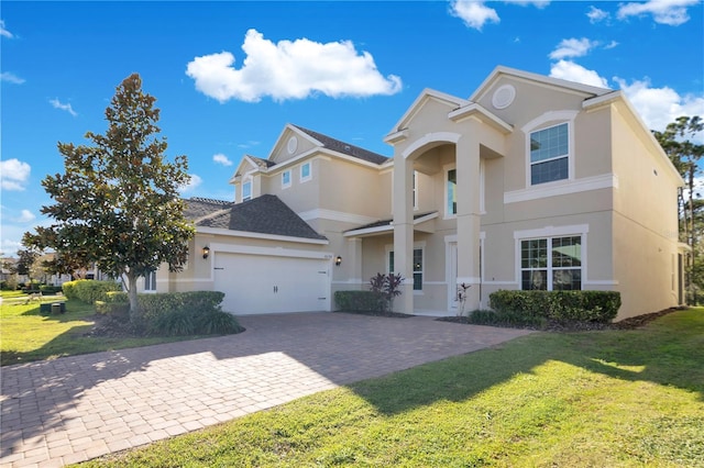 view of front of house featuring a front lawn and a garage