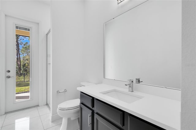 bathroom featuring tile patterned flooring, vanity, toilet, and an enclosed shower