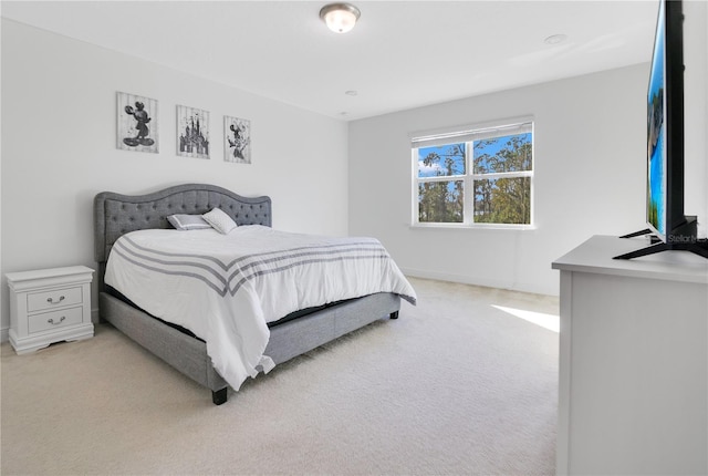 bedroom featuring light carpet