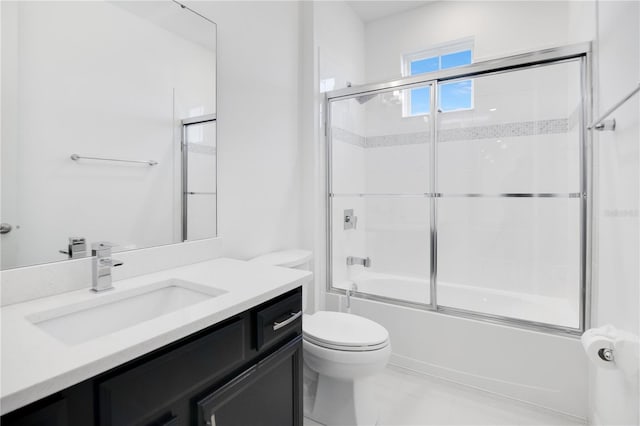 full bathroom featuring shower / bath combination with glass door, vanity, and toilet